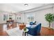 Open-concept living room connected to dining room with great natural lighting and hardwood floors at 1822 Painter Dr, Monument, CO 80132