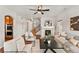 Bright living room features a fireplace, hardwood floors, comfortable seating, and ample natural light at 1822 Painter Dr, Monument, CO 80132