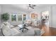 Bright living room with an open view to the kitchen and dining area, featuring large windows at 1822 Painter Dr, Monument, CO 80132