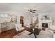 Open concept living room featuring a fireplace, hardwood floors, and stylish decor at 1822 Painter Dr, Monument, CO 80132