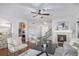Open living room with fireplace, hardwood floors and view to kitchen at 1822 Painter Dr, Monument, CO 80132