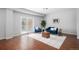 Cozy living room featuring hardwood floors, a plush blue sofa, and bright sliding glass doors to the patio at 1822 Painter Dr, Monument, CO 80132