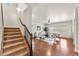Living room with hardwood floors, staircase, and lots of natural light from many windows at 1822 Painter Dr, Monument, CO 80132
