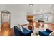 Cozy living room featuring hardwood floors, stylish furniture, and an open layout leading to the dining area at 1822 Painter Dr, Monument, CO 80132