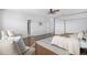 Spacious main bedroom features hardwood floors, a canopy bed, and multiple doors to an en-suite bathroom at 1822 Painter Dr, Monument, CO 80132
