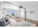 Bright main bedroom with large windows, hardwood floors, canopy bed, and a view of the neighborhood at 1822 Painter Dr, Monument, CO 80132