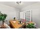 Home office with a wood desk, chair, and view into hallway with french doors at 1822 Painter Dr, Monument, CO 80132