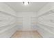 Spacious walk-in closet with multiple shelving units and tile floor at 1822 Painter Dr, Monument, CO 80132