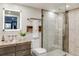 Modern bathroom featuring a glass-enclosed shower, floating vanity, and stylish tile work at 5553 S Chester Ct, Greenwood Village, CO 80111