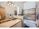 Bathroom showcasing a tiled shower and vanity with ample counter space at 440 Scrub Oak Cir, Monument, CO 80132