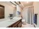 Bright bathroom with a large vanity, a shower with a bathtub, and good natural light with a skylight at 5046 S Evanston St, Aurora, CO 80015