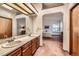 Bathroom with double sinks and doorway to bedroom at 5046 S Evanston St, Aurora, CO 80015