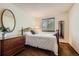 Bedroom featuring a full size bed, dresser, and window at 5046 S Evanston St, Aurora, CO 80015