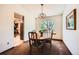 Bright dining room with a chandelier and a large window overlooking the backyard at 5046 S Evanston St, Aurora, CO 80015