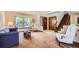 Inviting living room featuring a large window, staircase, and comfortable seating at 5046 S Evanston St, Aurora, CO 80015