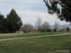 Park scene shows the vast community green space including picnic tables and benches at 5046 S Evanston St, Aurora, CO 80015