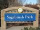 Sagebrush Park sign with blue background and the words Sagebrush Park in white letters at 5046 S Evanston St, Aurora, CO 80015