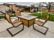 Backyard patio featuring outdoor seating and a fire pit with gazebo and kitchen area at 11964 W 71St Pl, Arvada, CO 80004