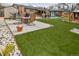 Artificial turf backyard featuring outdoor seating area, outdoor kitchen and gazebos at 11964 W 71St Pl, Arvada, CO 80004