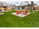 Backyard featuring outdoor seating around a fire pit with artificial turf and gazebos at 11964 W 71St Pl, Arvada, CO 80004