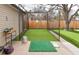 Backyard featuring a batting cage, artificial turf, and a putting practice area at 11964 W 71St Pl, Arvada, CO 80004