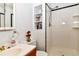 Classic white bathroom with updated shower and fixtures, contrasted with black trim at 11964 W 71St Pl, Arvada, CO 80004