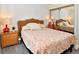 Cozy bedroom featuring a wicker headboard, floral bedding, and mirrored closet doors at 11964 W 71St Pl, Arvada, CO 80004