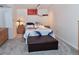 Cozy bedroom featuring neutral carpet and an eye-catching palm frond patterned comforter at 11964 W 71St Pl, Arvada, CO 80004