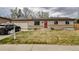 Charming single-story home featuring a red front door, attached garage, and well-maintained front yard at 11964 W 71St Pl, Arvada, CO 80004