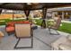 Backyard gazebo featuring comfortable seating, a fan and a view of the outdoor kitchen at 11964 W 71St Pl, Arvada, CO 80004