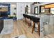 Stylish kitchen with a large island, breakfast bar seating, and stainless steel appliances at 11964 W 71St Pl, Arvada, CO 80004
