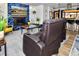 Comfortable living room with a cozy fireplace, plush seating, and stylish accents at 11964 W 71St Pl, Arvada, CO 80004