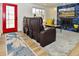 Bright living room featuring a fireplace, and red door to add a touch of color and style at 11964 W 71St Pl, Arvada, CO 80004