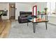 Inviting living room with modern decor, hardwood flooring, and a bright red front door at 11964 W 71St Pl, Arvada, CO 80004