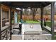 Outdoor kitchen featuring a large grill, bar, and view of putting green and outdoor seating at 11964 W 71St Pl, Arvada, CO 80004