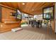 Inviting outdoor kitchen and dining area with a grill, covered seating, and TVs at 11964 W 71St Pl, Arvada, CO 80004