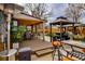Outdoor kitchen area with grill, dining table, and gazebo in backyard at 11964 W 71St Pl, Arvada, CO 80004