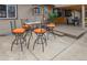 Outdoor patio with barstools, table and chairs near an open window for indoor/outdoor dining at 11964 W 71St Pl, Arvada, CO 80004