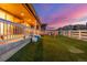 Lush backyard featuring manicured turf, play area, fenced perimeter, and covered patio at 4925 Coltin Trl, Castle Rock, CO 80104