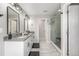 Bright bathroom with double vanity, modern lighting, glass shower, and tile flooring at 4925 Coltin Trl, Castle Rock, CO 80104