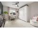 Neutral bedroom with a large wardrobe, desk area, and cozy seating, bathed in soft natural light at 4925 Coltin Trl, Castle Rock, CO 80104
