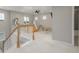Bright bonus room with natural light, neutral paint, a play area, and wooden railing at 4925 Coltin Trl, Castle Rock, CO 80104