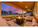 Inviting covered patio with plush seating and a fire pit, perfect for outdoor entertaining at dusk at 4925 Coltin Trl, Castle Rock, CO 80104