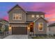Charming two-story home with a well-maintained yard and a brown two car garage at 4925 Coltin Trl, Castle Rock, CO 80104