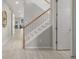 Bright foyer with a white staircase and a coat closet with a barn door at 4925 Coltin Trl, Castle Rock, CO 80104