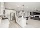 Open-concept kitchen featuring stainless steel appliances, a white island and hardwood floors at 4925 Coltin Trl, Castle Rock, CO 80104