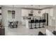 Well-lit kitchen with a large island, stainless steel appliances, and modern pendant lights at 4925 Coltin Trl, Castle Rock, CO 80104