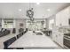 Bright living room with a large marble kitchen island, and dining table at 4925 Coltin Trl, Castle Rock, CO 80104