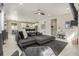 Spacious living room featuring gray L-shaped sofa and an open concept kitchen with a breakfast bar at 4925 Coltin Trl, Castle Rock, CO 80104
