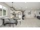 A modern dining area that blends into a bright kitchen, featuring a spacious table and modern lighting at 4925 Coltin Trl, Castle Rock, CO 80104